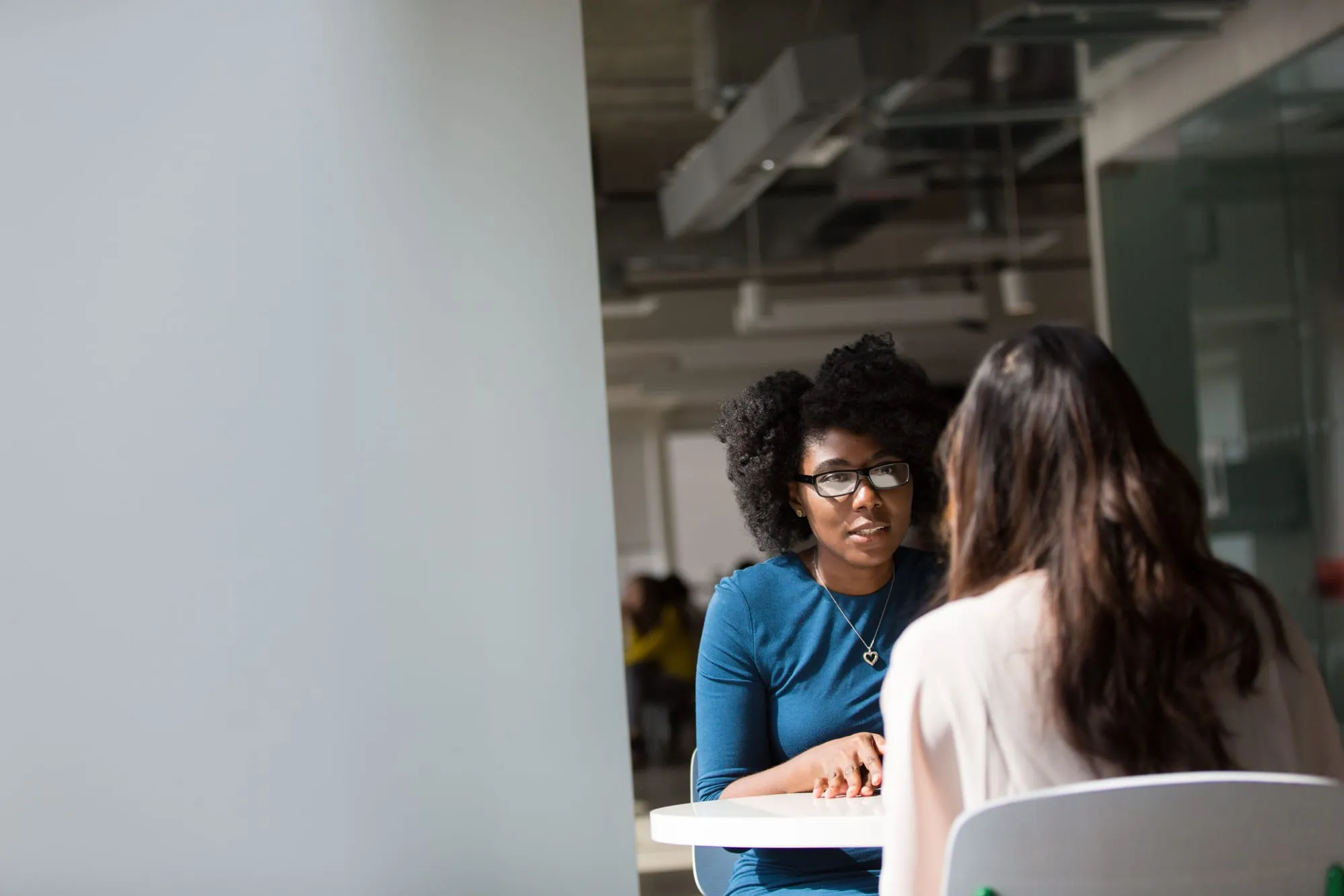 Two colleagues reviewing a plan together in a bright office